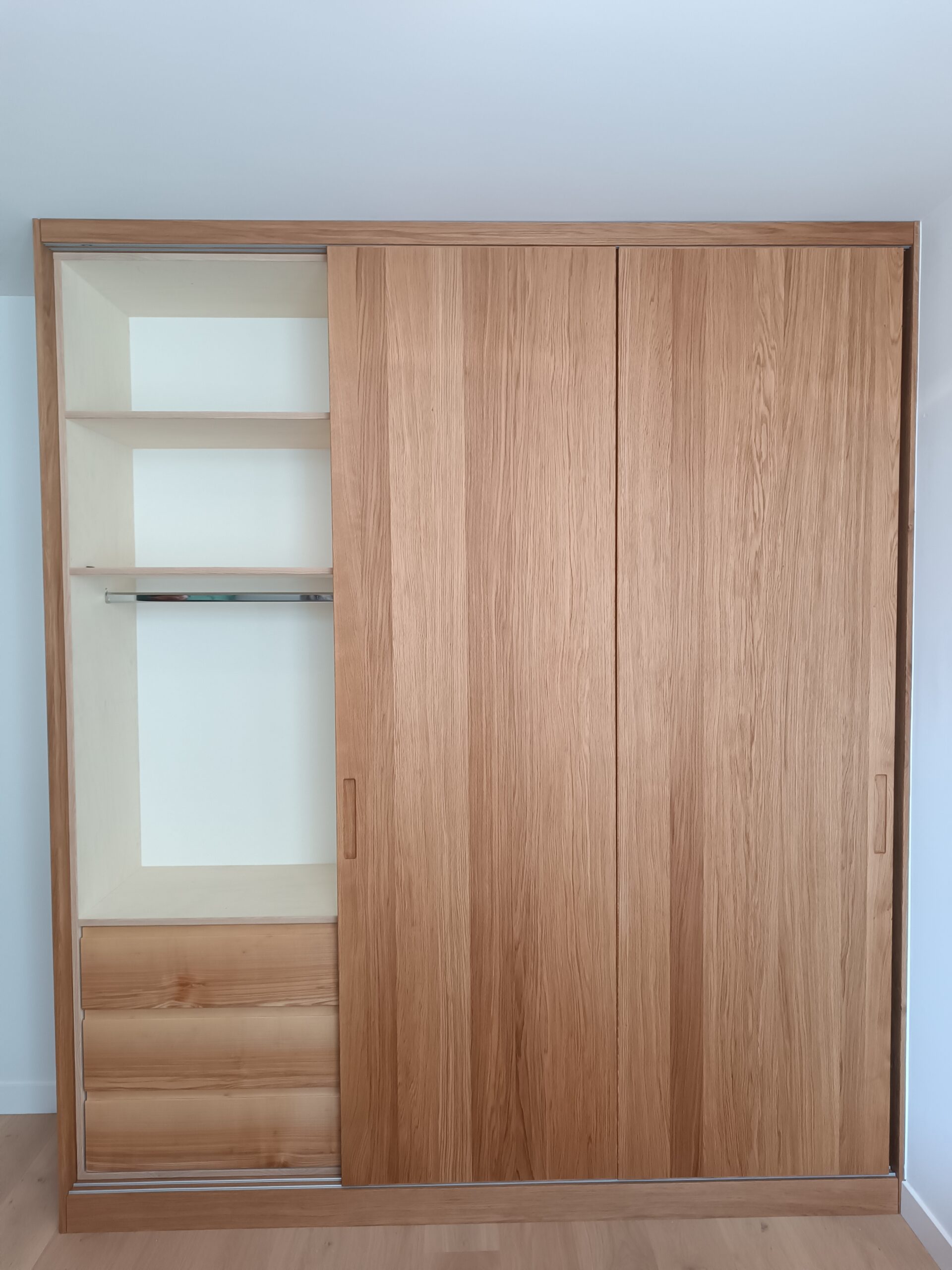 Custom-made oak veneer cabinet with sliding doors open showing interior shelving