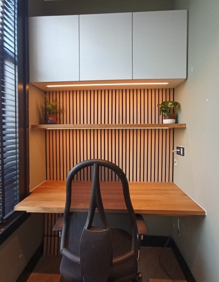 Integrated custom desk and slatted oak workstation, straight-on view